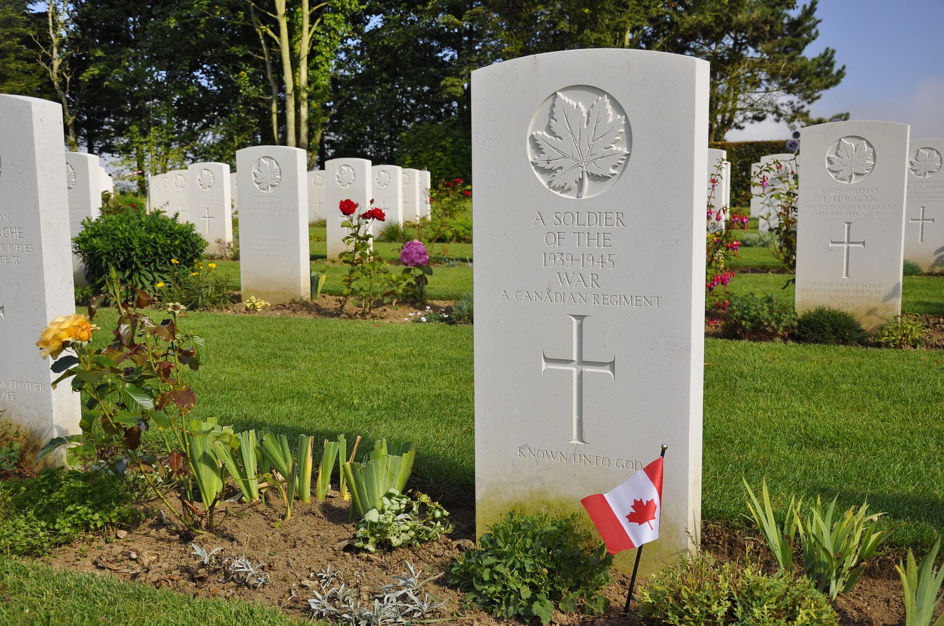 Normandy to victory tours Canadian tour Grave wi Flag
